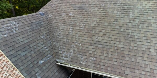 Aerial View Of A Shingle Roof With Chalk Markings Indicating Potential Damage.